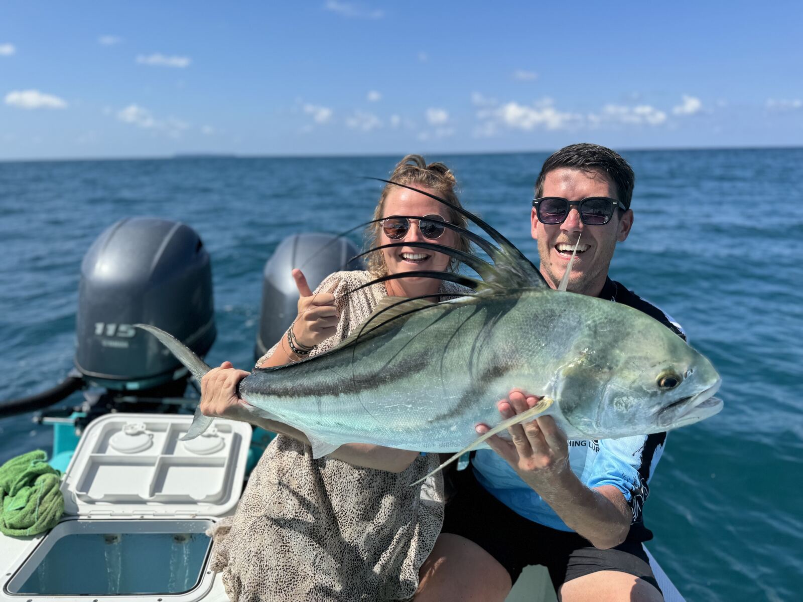 A couple with a freshly caught roosterfish